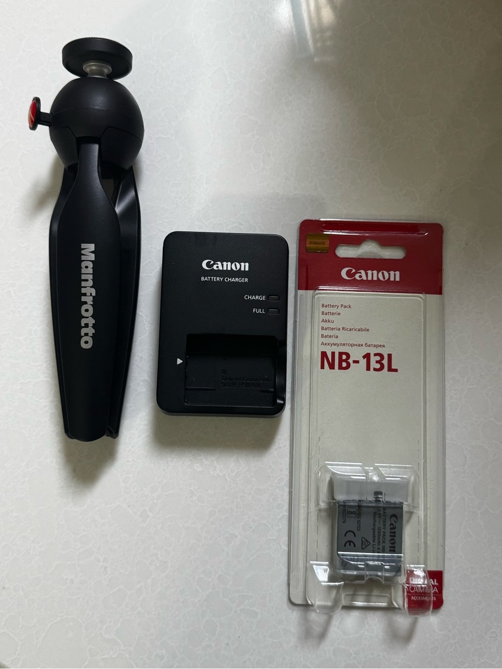 Canon NB-13L Battery Pack, Canon Charger, and Manfrotto Black Tripod